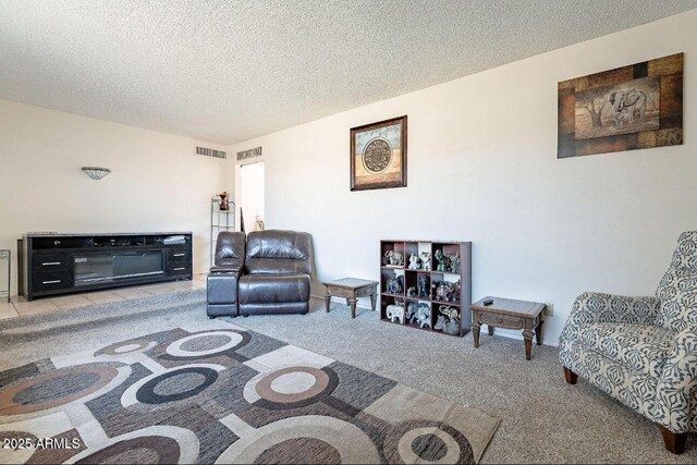 living area with a textured ceiling and carpet flooring