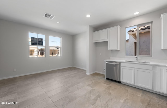 kitchen with visible vents, dishwasher, light countertops, white cabinetry, and a sink