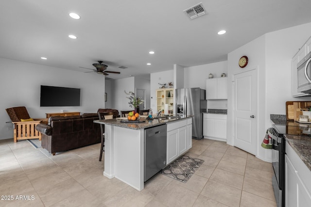 kitchen featuring visible vents, appliances with stainless steel finishes, a ceiling fan, and white cabinetry