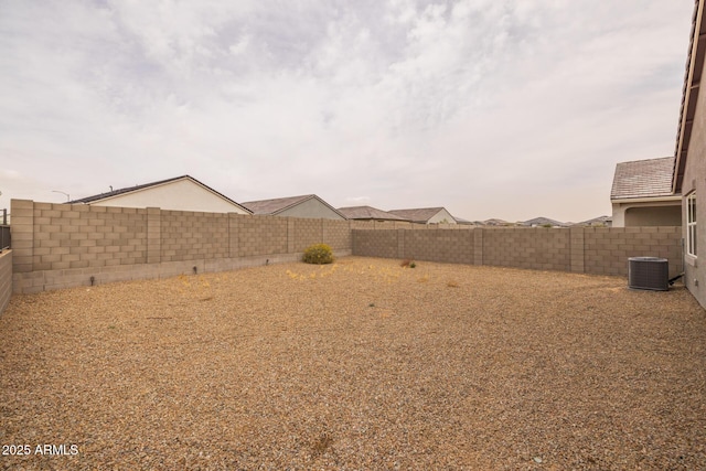 view of yard featuring central AC unit and a fenced backyard