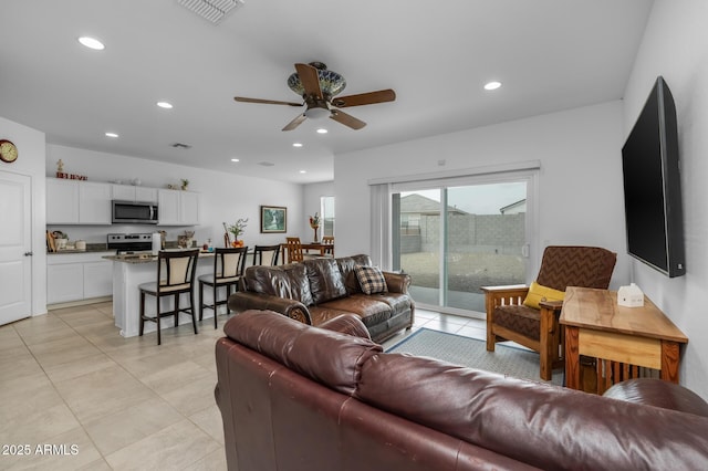 living room with recessed lighting, visible vents, ceiling fan, and light tile patterned floors