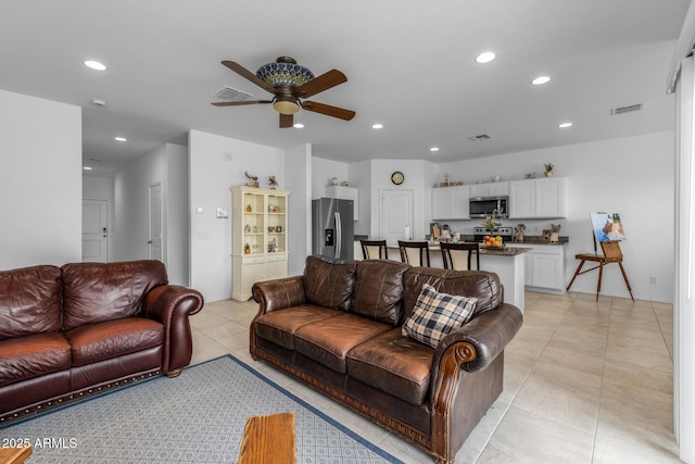 living area with light tile patterned floors, recessed lighting, visible vents, and ceiling fan