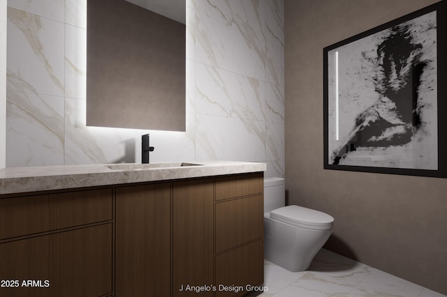 bathroom featuring marble finish floor, vanity, toilet, and tile walls