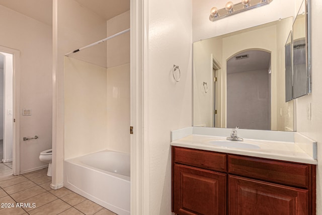 full bathroom with tile patterned floors, vanity, tub / shower combination, and toilet