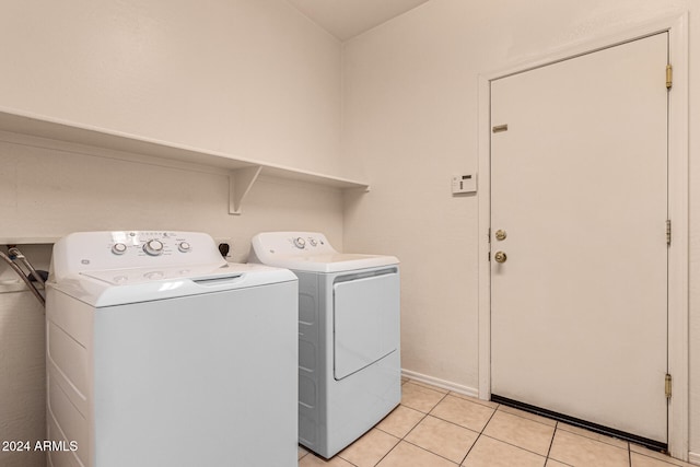 washroom with washer and dryer and light tile patterned floors