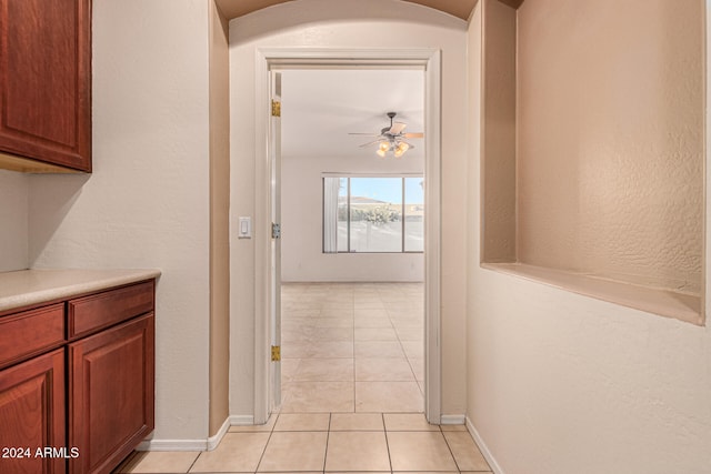 corridor featuring light tile patterned floors