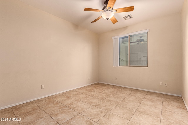 tiled empty room with ceiling fan