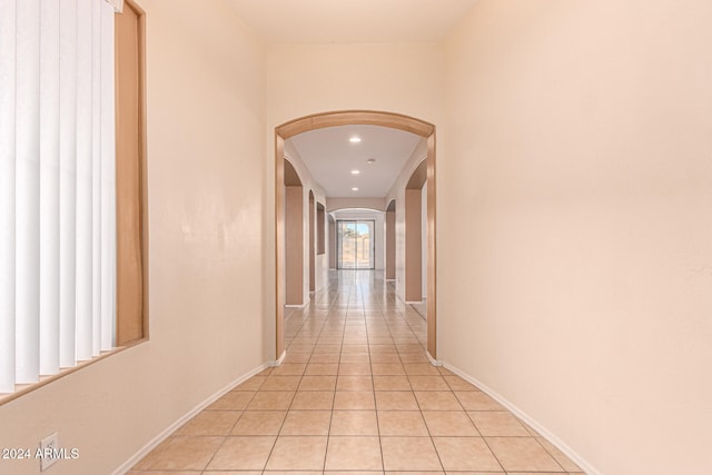 hall featuring light tile patterned flooring