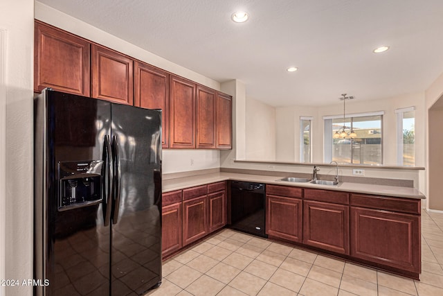 kitchen featuring sink, kitchen peninsula, pendant lighting, light tile patterned flooring, and black appliances