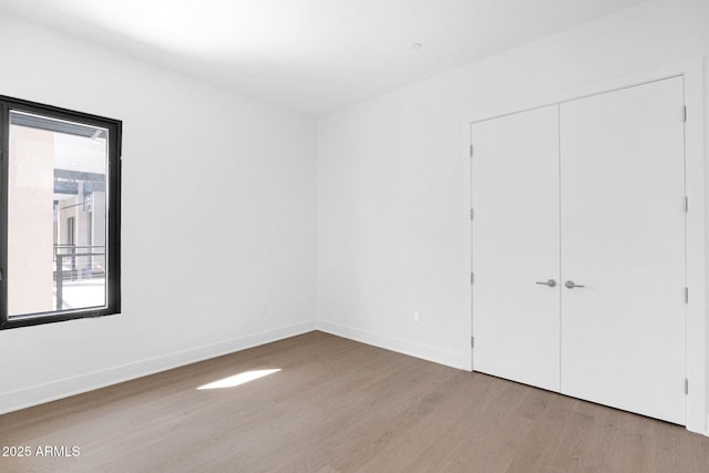 19355 N 73rd Way Unit 4002, Scottsdale, AZ 85255 - unfurnished bedroom with a closet, wood finished floors, and baseboards