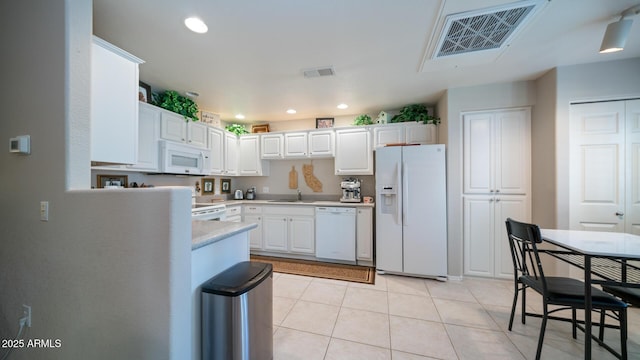 15252 N 100th St Unit 1134, Scottsdale, AZ 85260 - kitchen with white appliances, a sink, light countertops, white cabinets, and light tile patterned floors