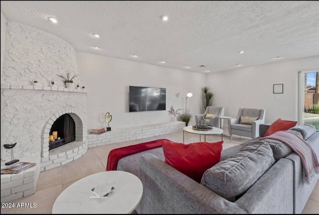 tiled living area featuring a fireplace, a textured ceiling, and recessed lighting