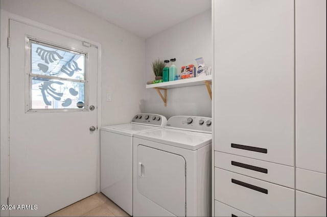 laundry room featuring laundry area, washer and clothes dryer, and light tile patterned floors