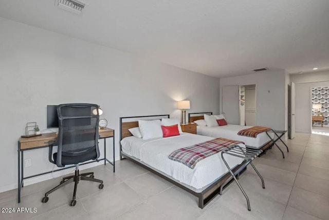 tiled bedroom featuring visible vents and baseboards