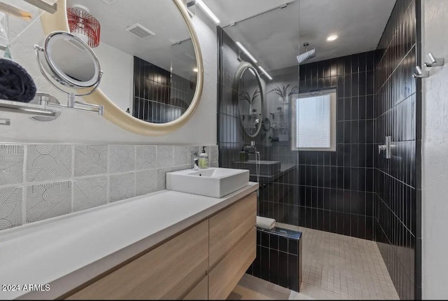 bathroom with a walk in shower, visible vents, and vanity