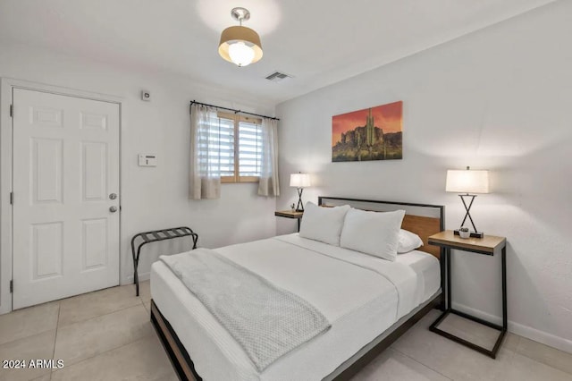 bedroom with light tile patterned floors, visible vents, and baseboards