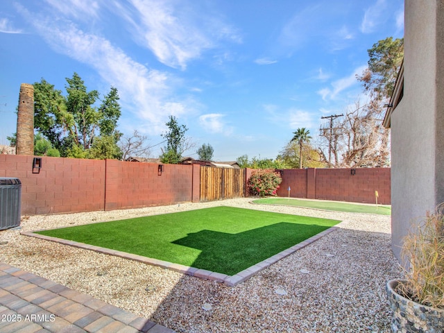 view of yard featuring central AC, a patio area, and a fenced backyard