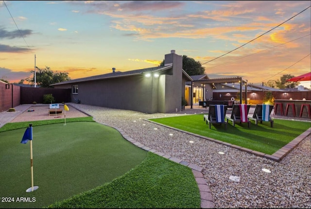 exterior space featuring a patio, a chimney, stucco siding, a pergola, and a fenced backyard