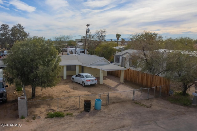 view of front of home with driveway, a fenced front yard, and a gate