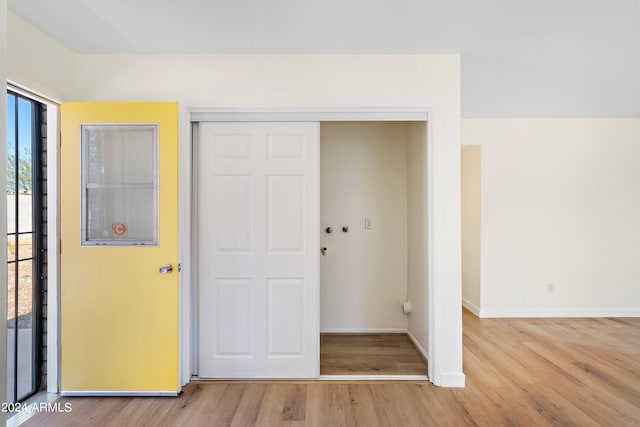 unfurnished bedroom featuring light hardwood / wood-style flooring, access to outside, and a closet