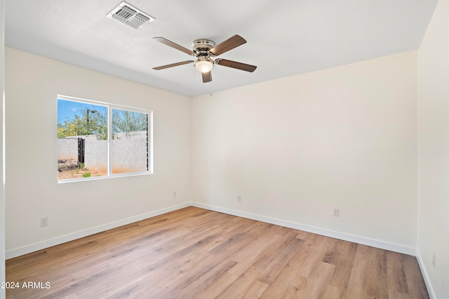 spare room featuring light hardwood / wood-style floors and ceiling fan