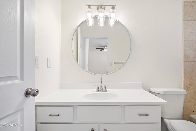 bathroom featuring ceiling fan, toilet, and vanity