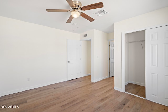 unfurnished bedroom with light hardwood / wood-style floors, a closet, and ceiling fan