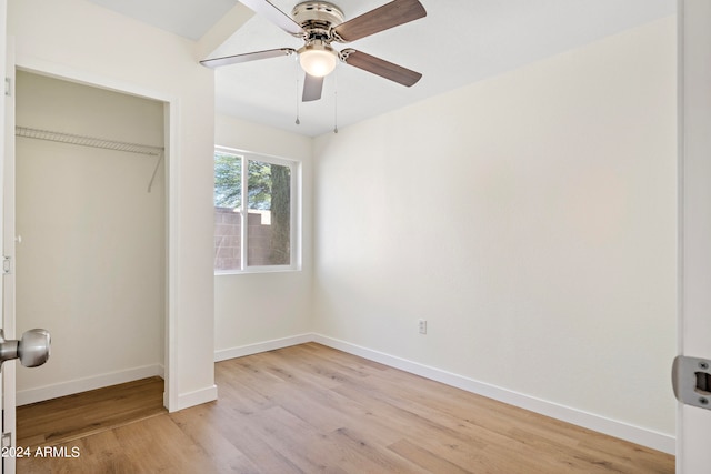 unfurnished bedroom with a closet, ceiling fan, and light wood-type flooring