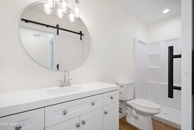 bathroom featuring vanity, wood-type flooring, toilet, and walk in shower