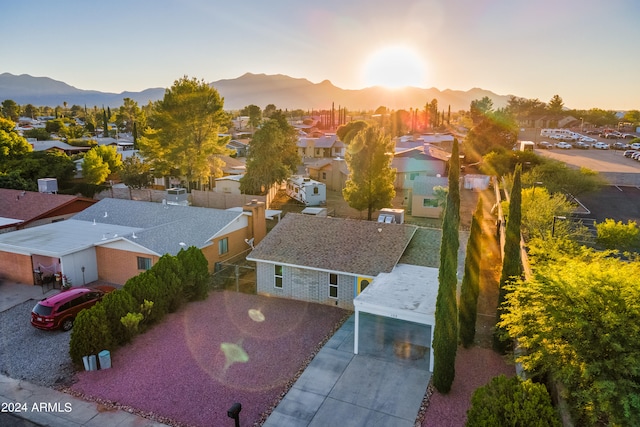 aerial view at dusk featuring a mountain view