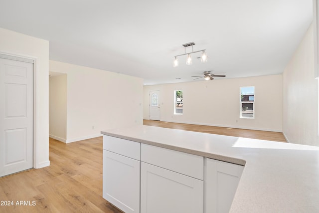 kitchen featuring ceiling fan, white cabinetry, light hardwood / wood-style flooring, and rail lighting