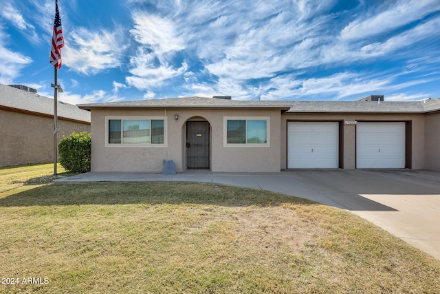 ranch-style home with a front lawn and a garage