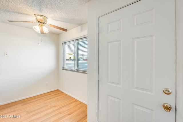 unfurnished room with hardwood / wood-style floors, a textured ceiling, and ceiling fan