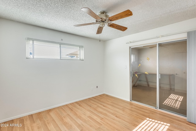 unfurnished bedroom with ceiling fan, a closet, a textured ceiling, and light hardwood / wood-style flooring