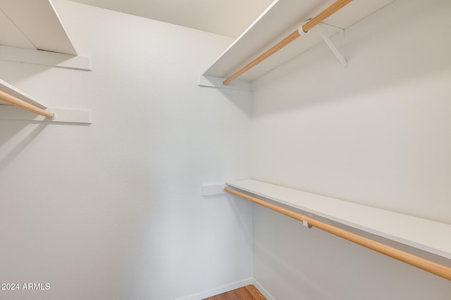 walk in closet with hardwood / wood-style floors