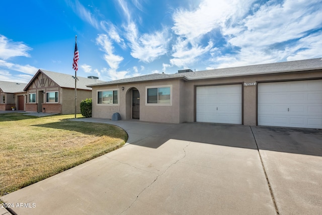 ranch-style home featuring a front yard and a garage