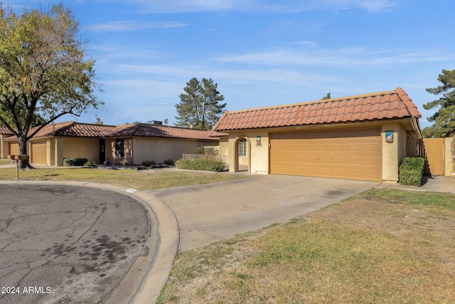 view of front of home featuring a garage and a front yard