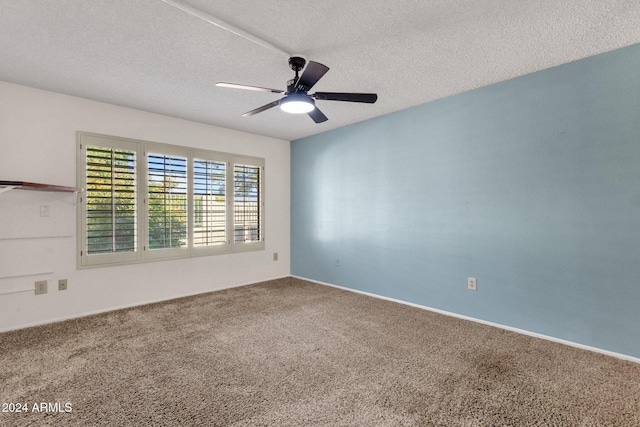 spare room featuring ceiling fan, carpet, and a textured ceiling