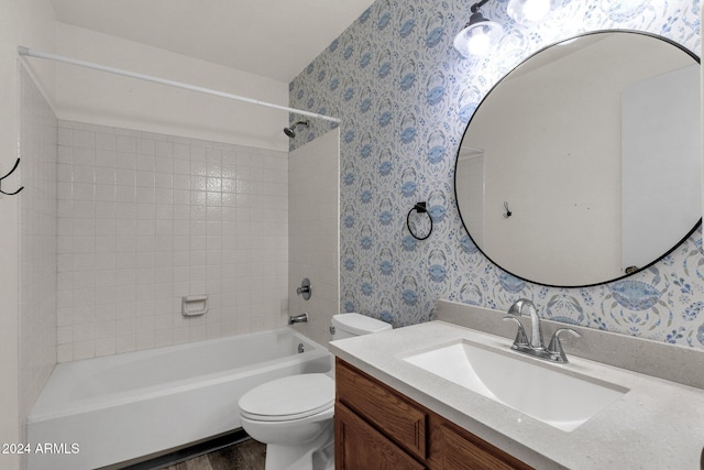 full bathroom featuring vanity, tiled shower / bath, wood-type flooring, and toilet