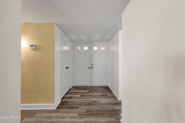 foyer entrance featuring wood-type flooring and a textured ceiling