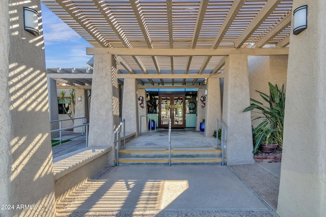 property entrance featuring a pergola