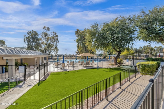 view of property's community featuring a water view and a lawn