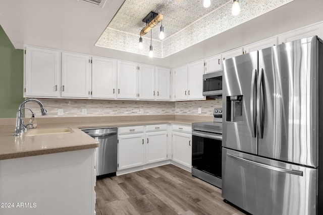 kitchen featuring white cabinets, stainless steel appliances, and sink