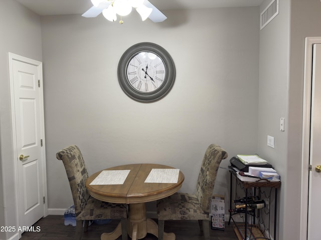 dining room featuring visible vents, baseboards, wood finished floors, and a ceiling fan