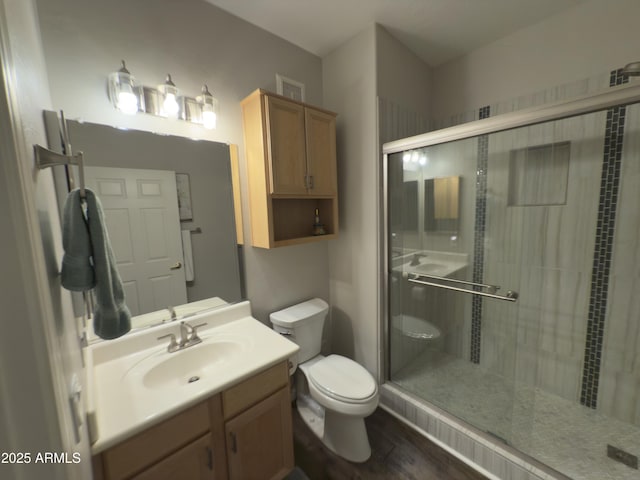 bathroom featuring visible vents, toilet, a stall shower, and vanity