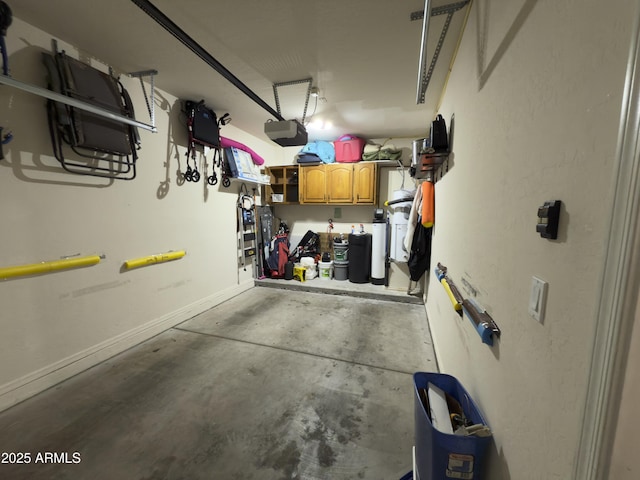 garage with a garage door opener and baseboards