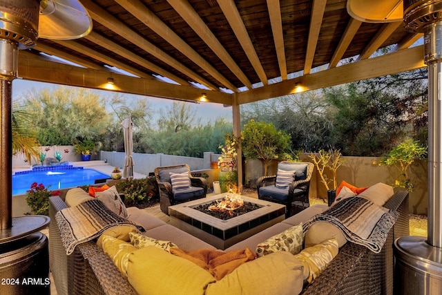 patio terrace at dusk featuring a fire pit and a fenced in pool