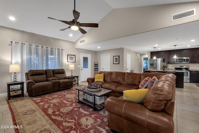 tiled living room with high vaulted ceiling and ceiling fan