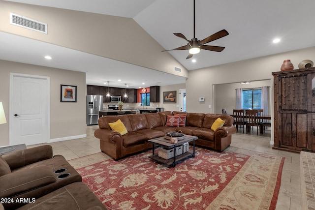 living room with ceiling fan and high vaulted ceiling