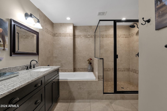 bathroom with tile patterned flooring, vanity, and separate shower and tub